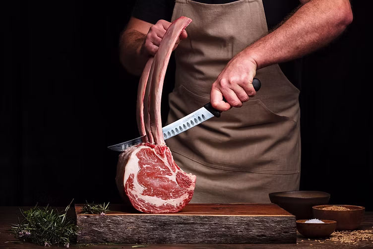 A chef preparing premium meat